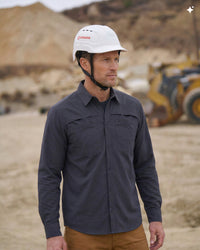 A bright white STRAUSS Baseball Style Hard Hat with a visor on a model as seen from the side.