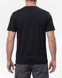 A model wears the STRAUSS Artwork T-Shirt e.s.e:pic in black with work pants and work boots, showing the shirt fit
