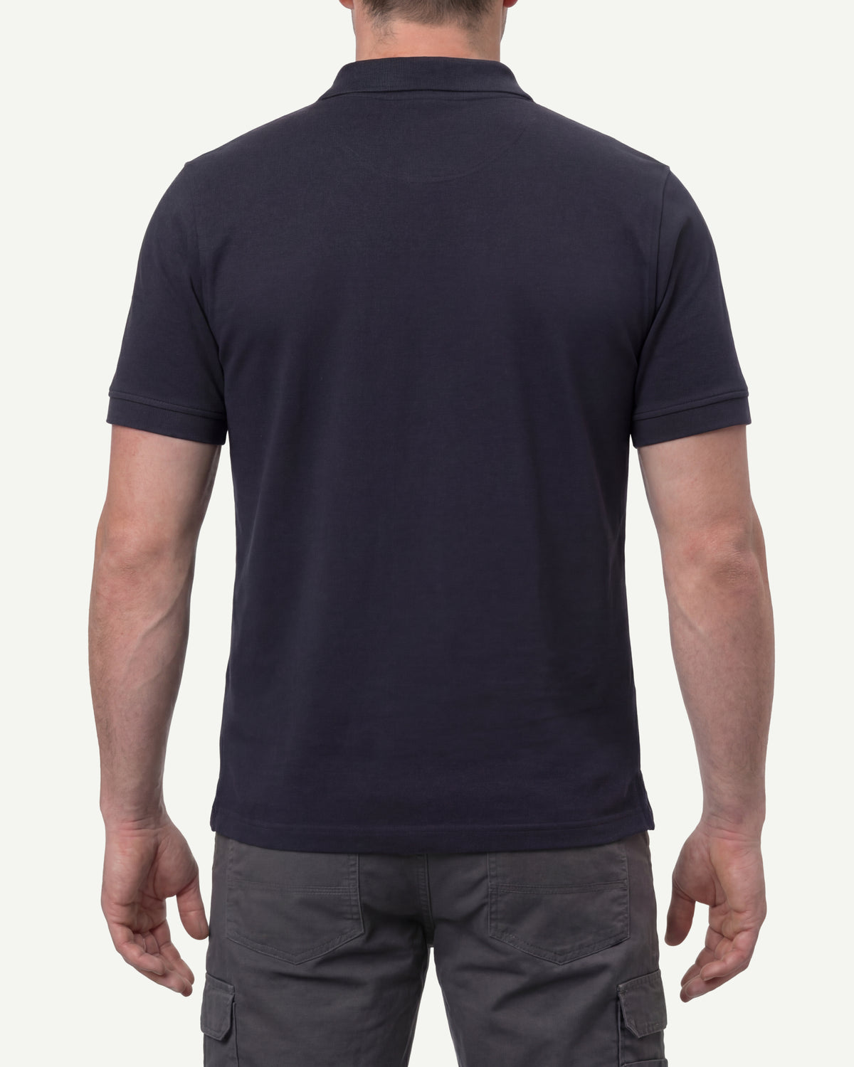 A model wears the STRAUSS Cotton Stretch Polo Shirt in nero blue, showing the shirt fit
