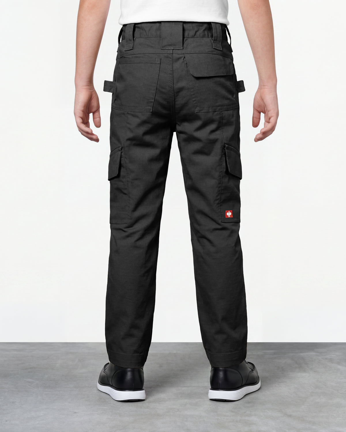Kids' Double Front Ripstop Cargo Pants e.s.e:pic in black worn by a model, rear view