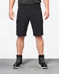 Model wearing Engelbert Strauss e.s. taktik stretch ripstop cargo work shorts in black, showing the fit, length, waistband, and front pocket layout of the durable stretch ripstop cargo work shorts with utility pockets.