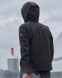 STRAUSS women's e.s.trail light pack windbreaker in black in use on the job