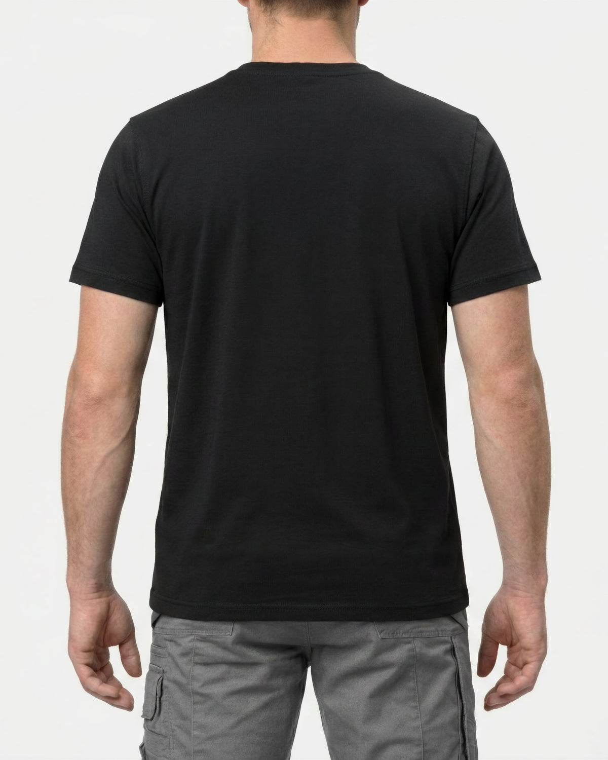 A model wears the STRAUSS Cotton T-Shirt in black with tan work pants and work boots, showing the shirt fit