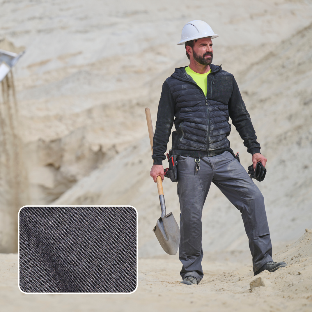 A man in a construction environment and a special focus on the twill fabric