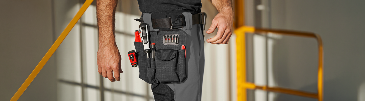 A man wearing the e.s.tool concept belt with an attached tool bag.