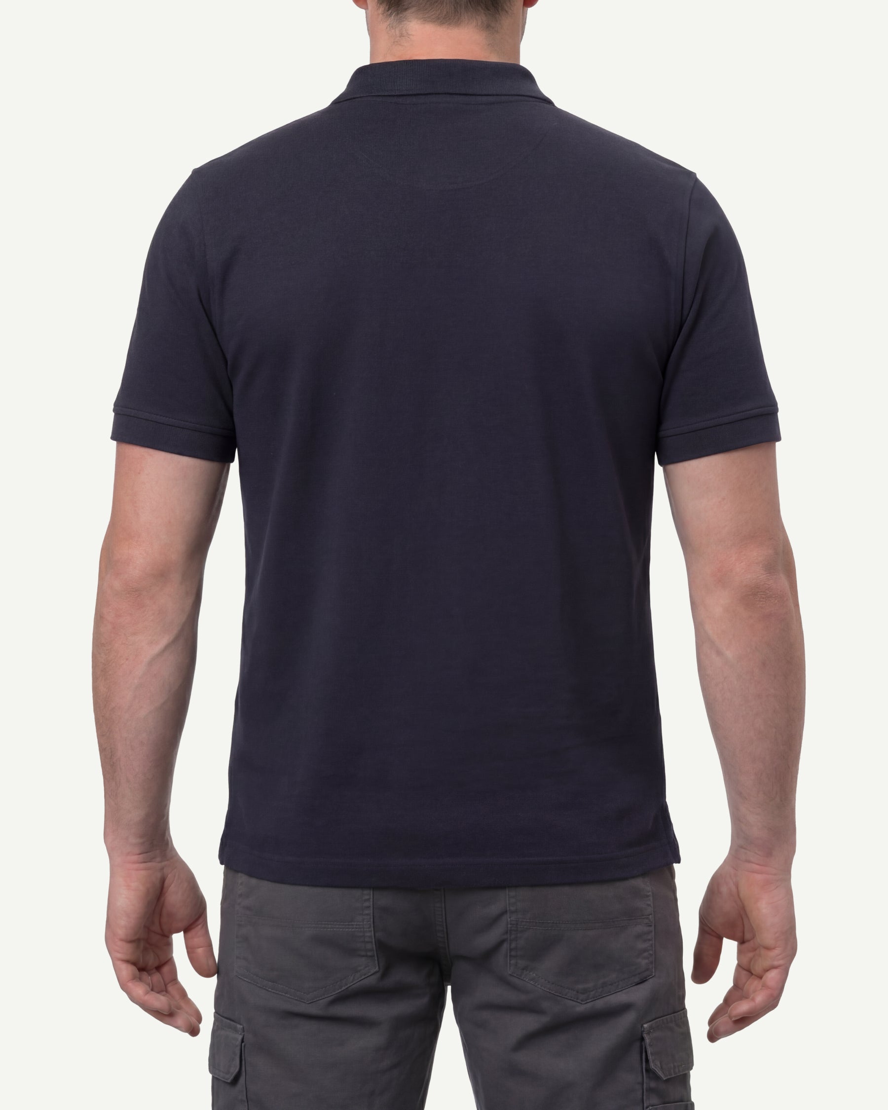 A model wears the STRAUSS Cotton Stretch Polo Shirt in nero blue, showing the shirt fit