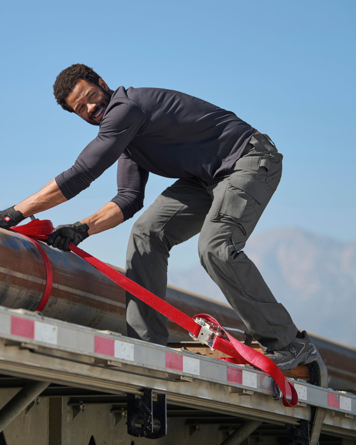 Lifestyle view of Ripstop Cargo Work Pants e.s.e:pic in carbon gray during work
