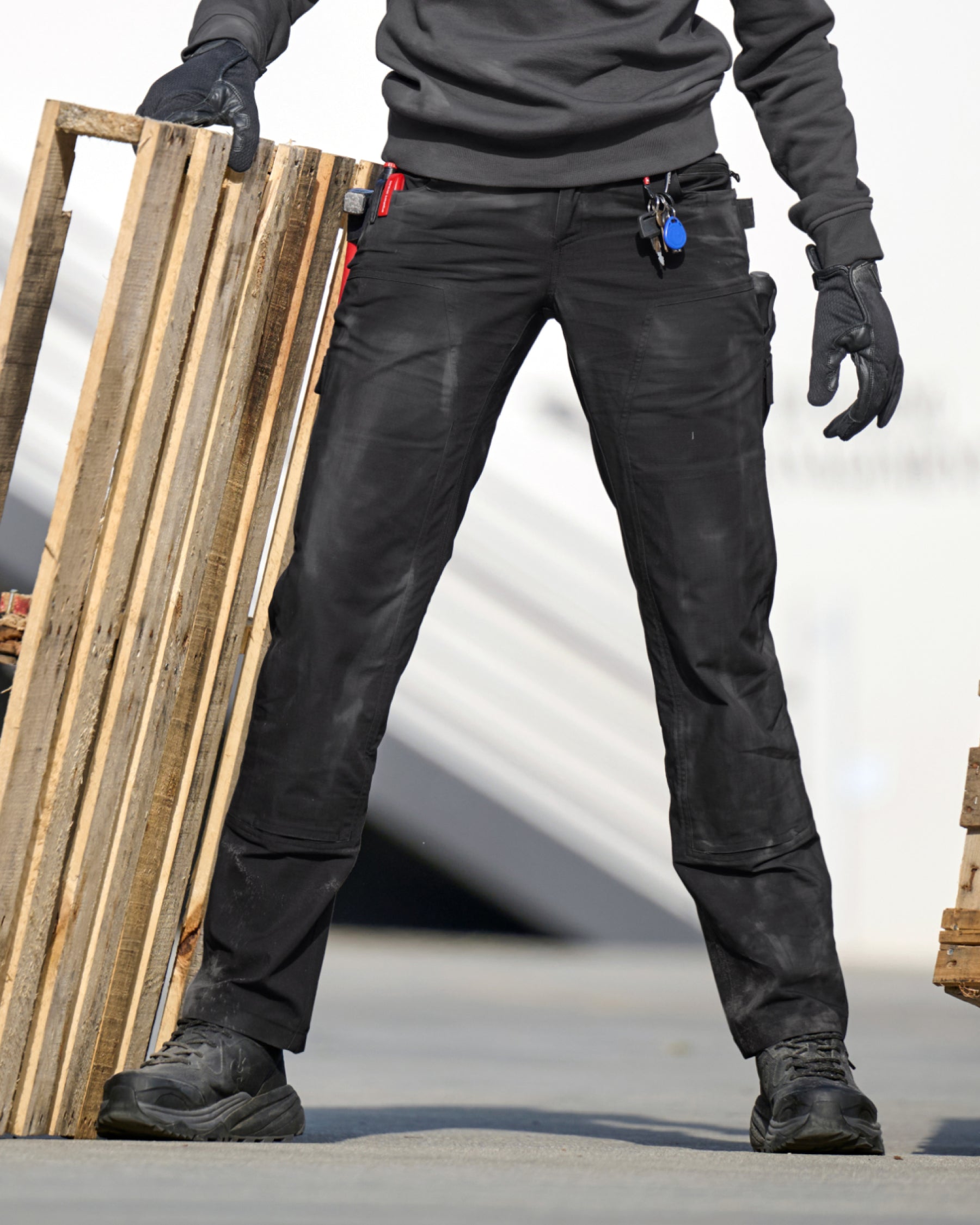 Women's Double Front Ripstop Cargo Work Pants e.s.e:pic in black worn in a work setting