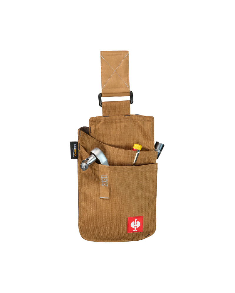 Small almond brown STRAUSS e.s.motion 2020 tool bag with hand tools stored in its layered pockets.