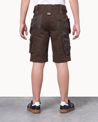 A person shown from the back wearing dark brown cargo shorts with multiple flap pockets and a matching belt, paired with black sneakers, against a plain light studio background.