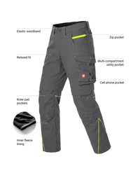Dark gray technical work pants with bright yellow-green contrast stitching and multiple utility pockets, shown with callout labels pointing to features like elastic waistband, zip pocket, multi-compartment utility pocket, and knee pad pockets.