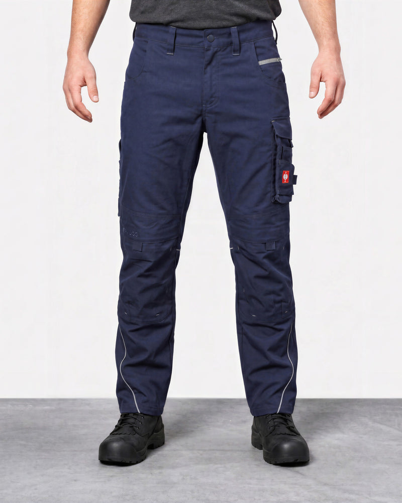 Front view of someone a studio wearing navy blue cargo work pants with black shoes and a dark grey sweatshirt