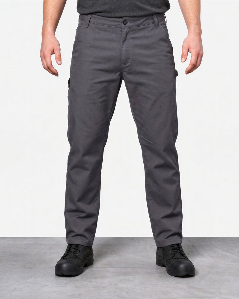 Front view of a model wearing carbon gray STRAUSS work pants with black work shoes.