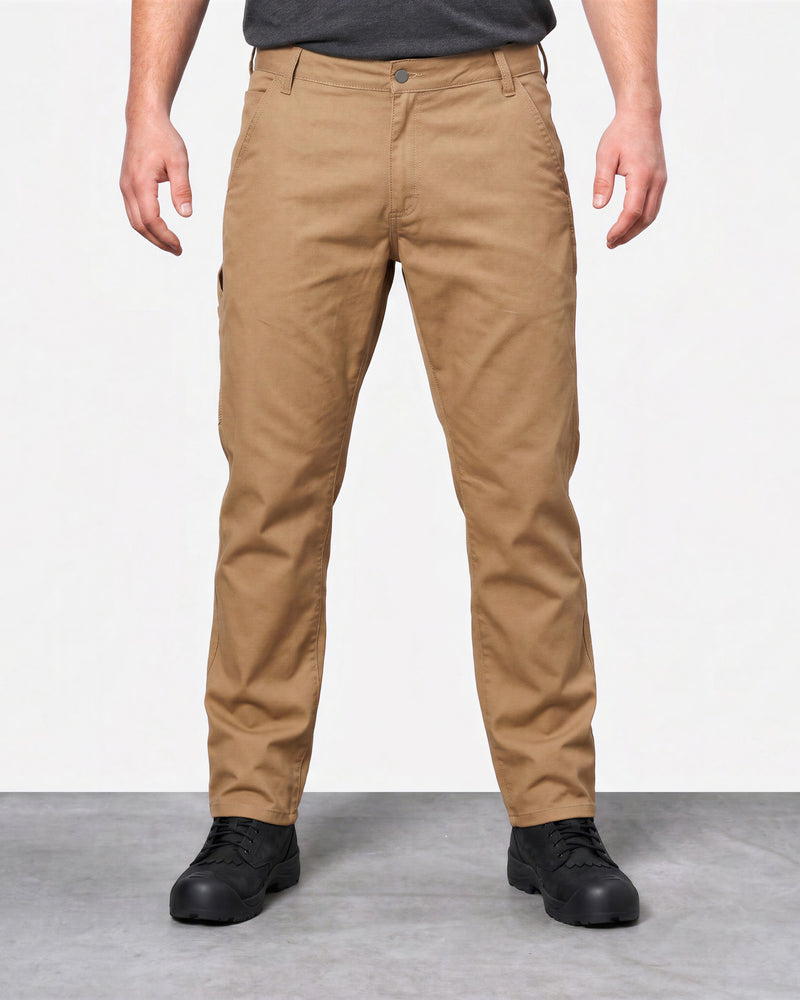 Front view of a model wearing almond brown STRAUSS canvas work pants with black work shoes.