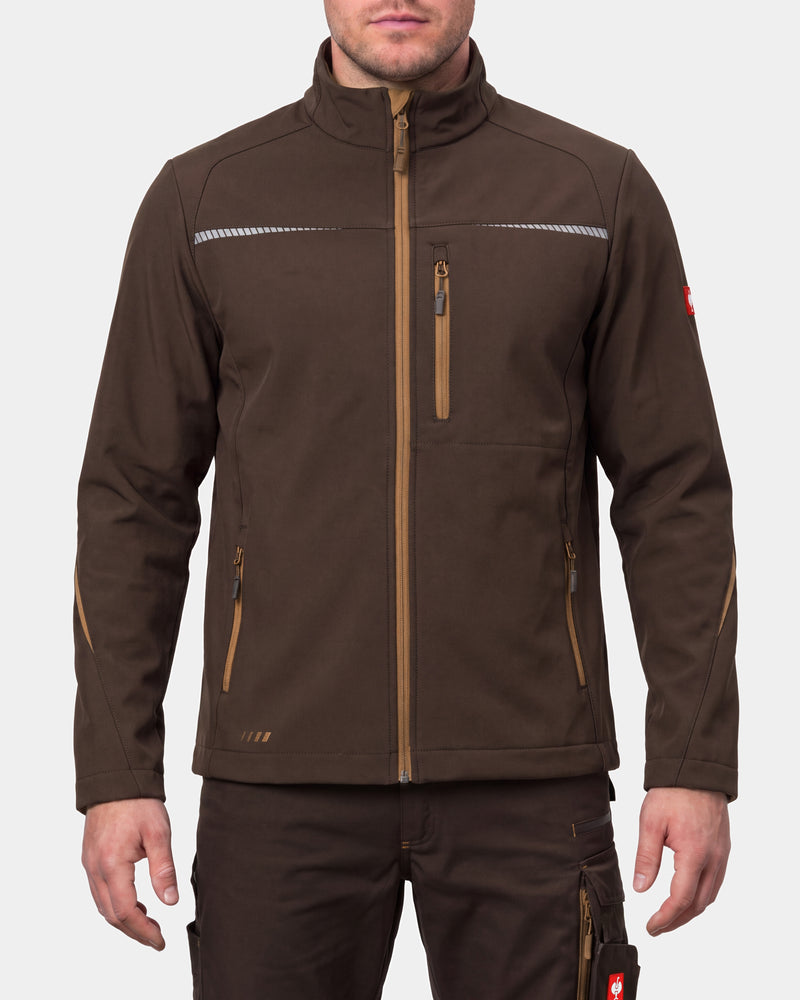 A man wearing a brown technical softshell jacket with tan zipper details and reflective chest stripes, paired with matching brown pants, against a light gray studio background.