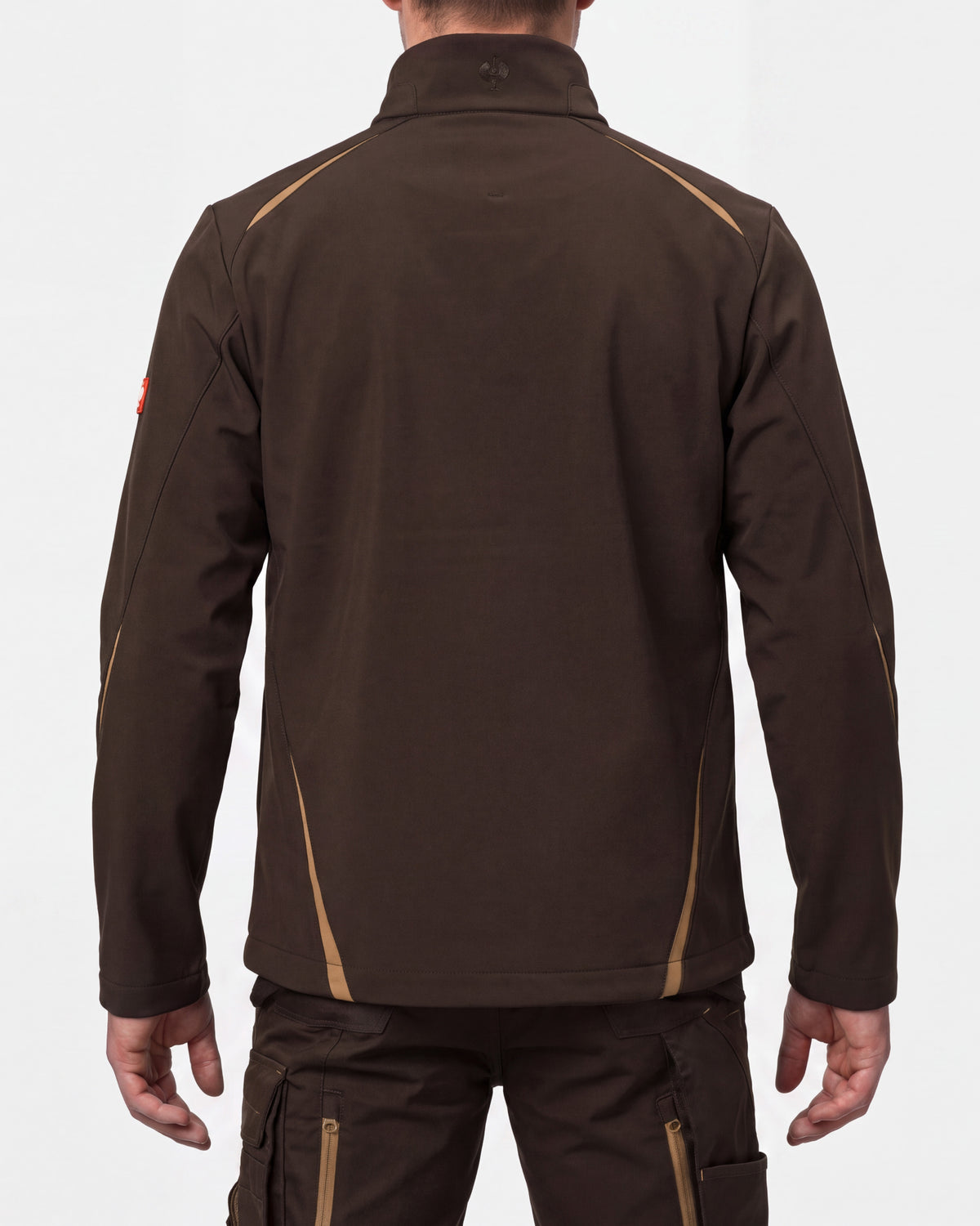 A man viewed from the back wearing a dark brown long-sleeve work jacket with tan contrast stitching and dark brown cargo pants against a light gray studio background.