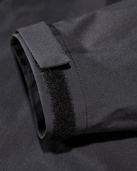 Close-up of hood and pocket details on STRAUSS women's e.s.trail light pack windbreaker in black