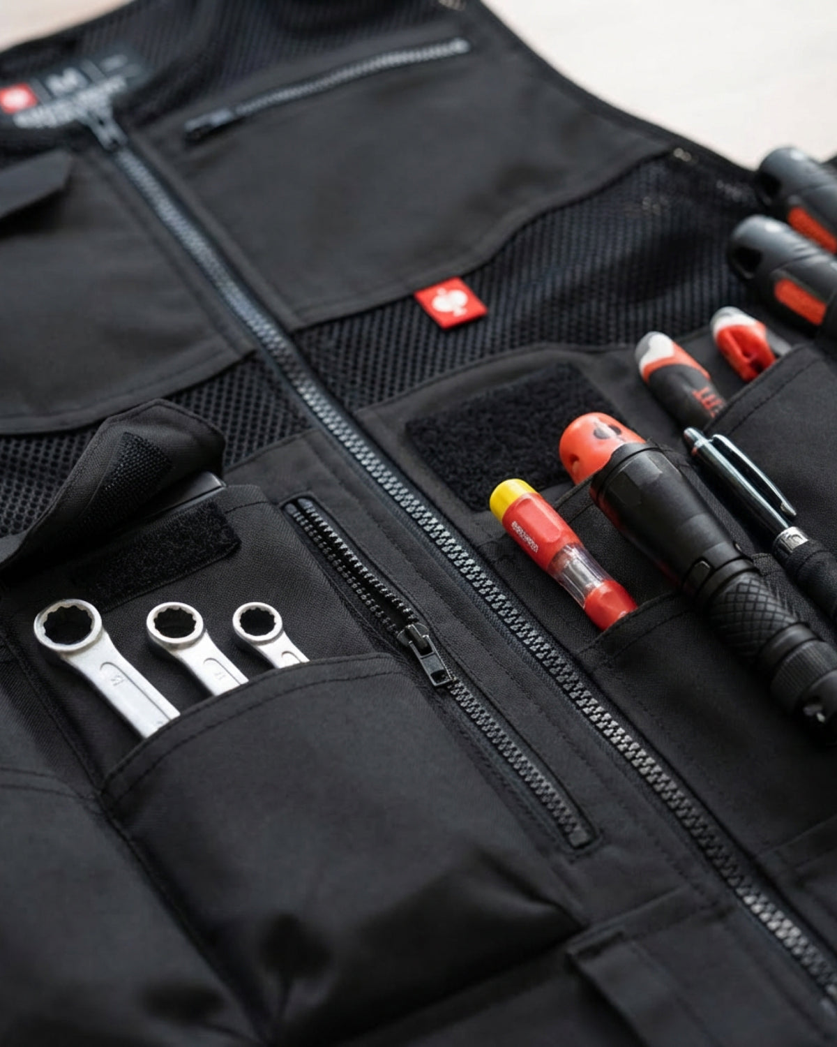Close-up of reinforced pocket and closure details on STRAUSS e.s.iconic tool vest in black