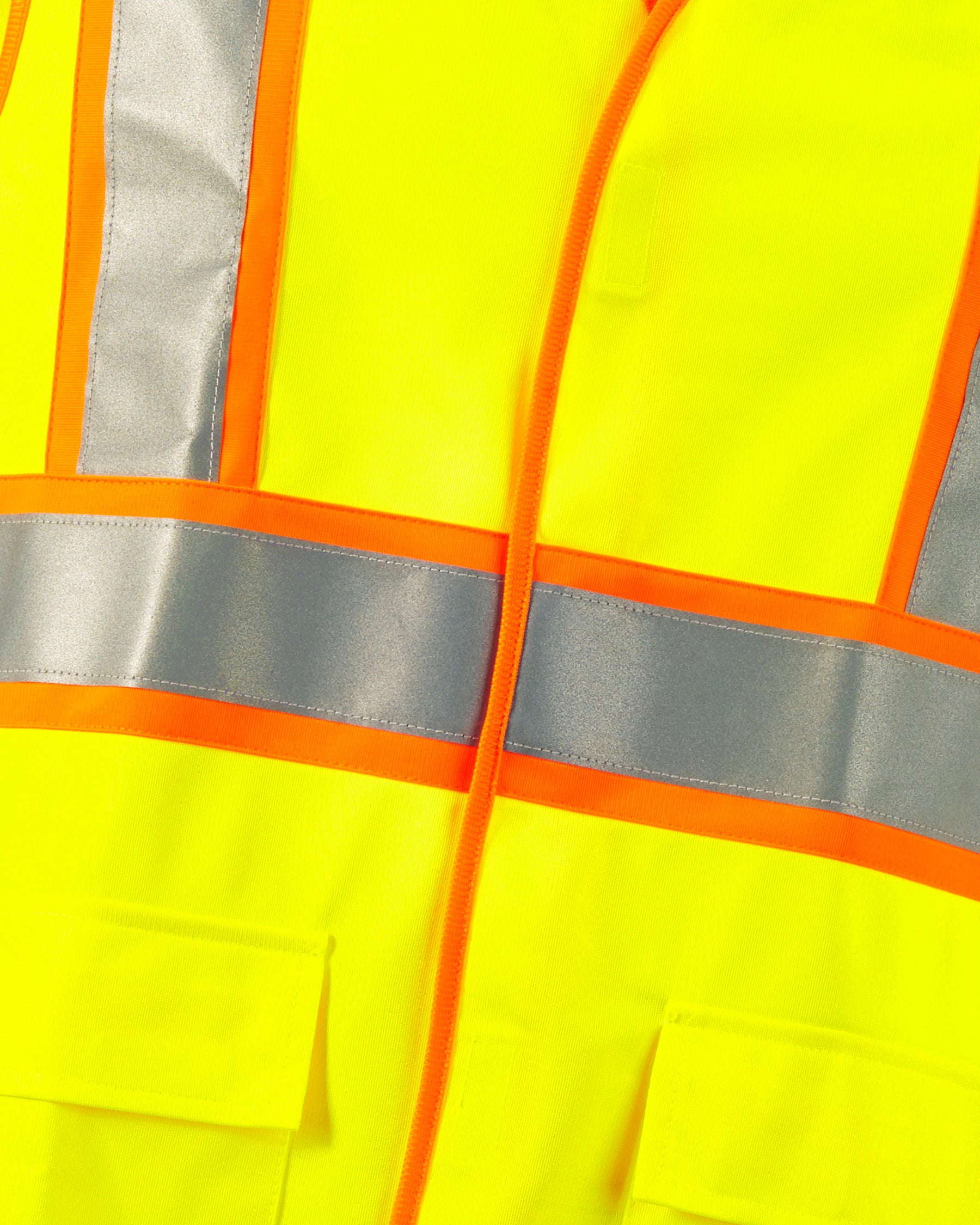 Close-up of reflective striping and shell details on STRAUSS high visibility vest in neon yellow