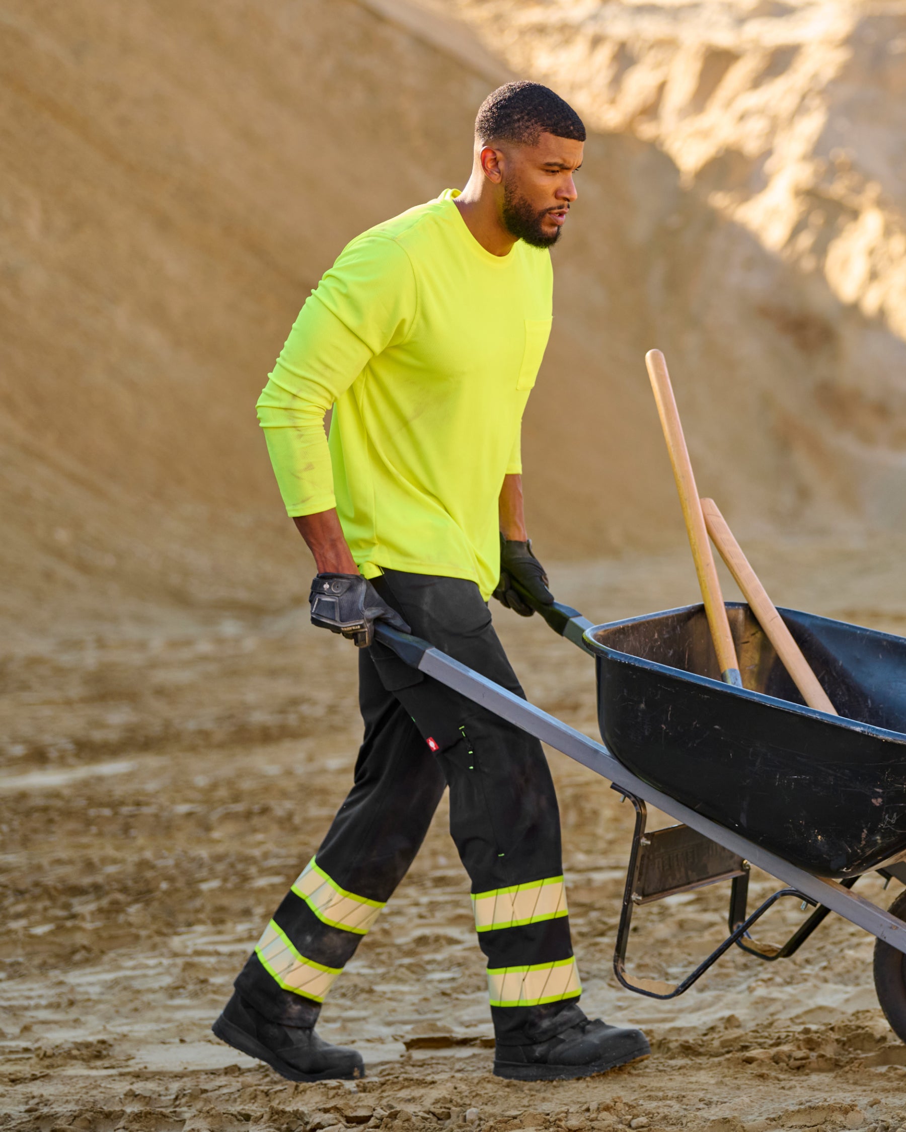 Enhanced Visibility Work Pants in black shown in an outdoor workwear setting