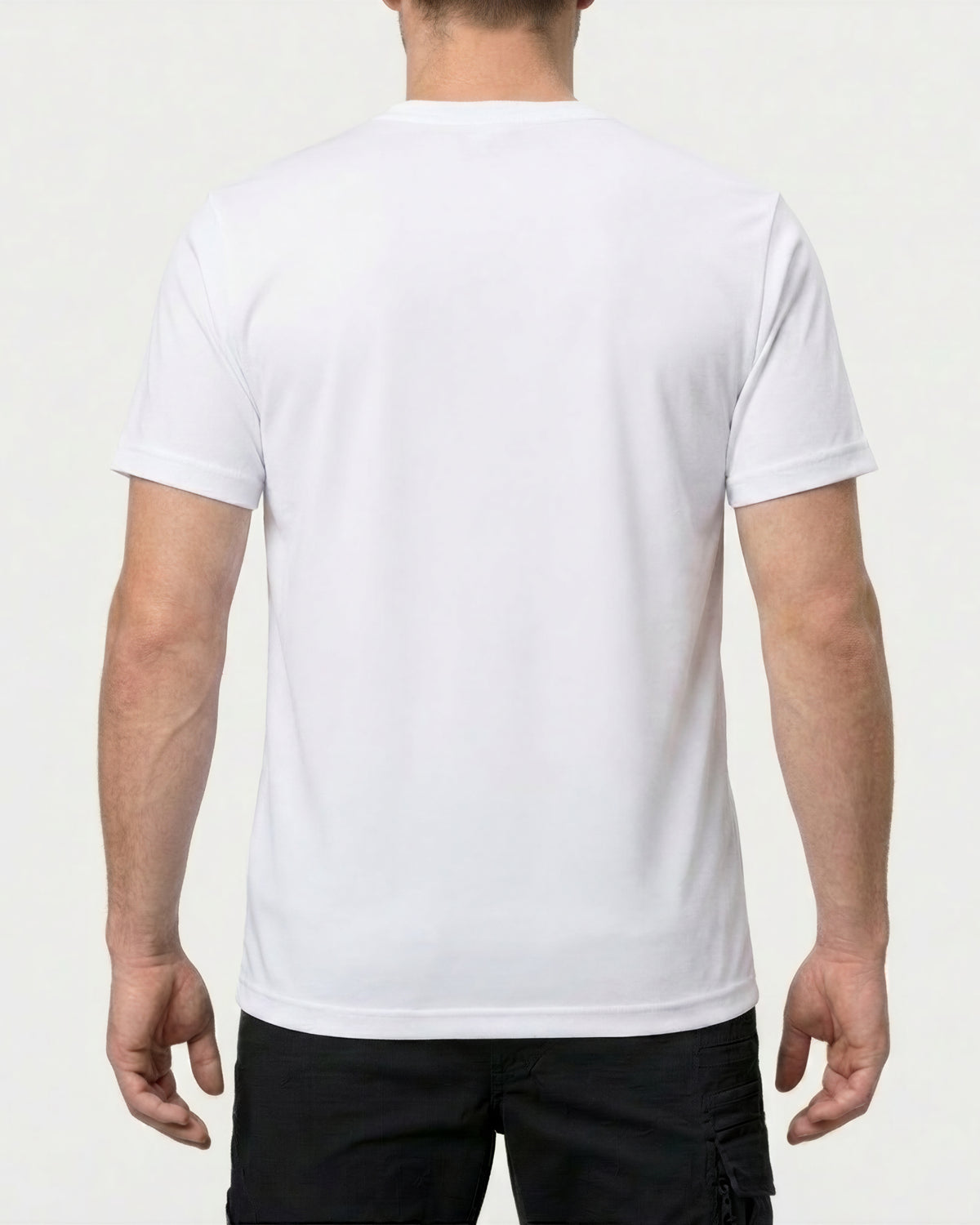 A model wears the STRAUSS Cotton T-Shirt in white with tan work pants and work boots, showing the shirt fit