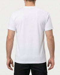 A model wears the STRAUSS Cotton T-Shirt in white with tan work pants and work boots, showing the shirt fit