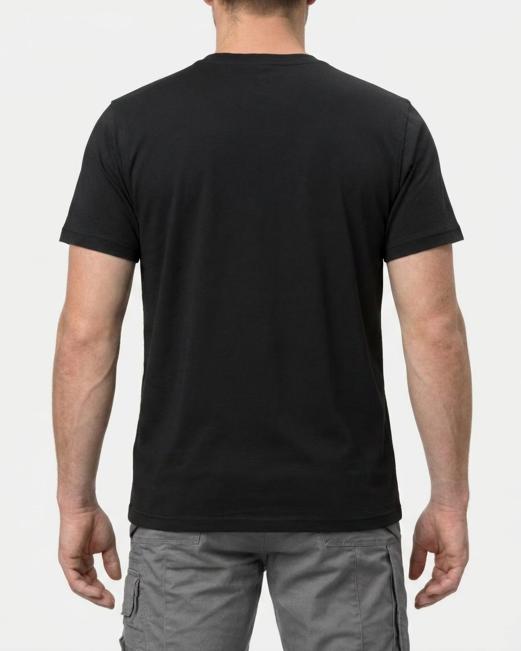A model wears the STRAUSS Cotton T-Shirt in black with tan work pants and work boots, showing the shirt fit