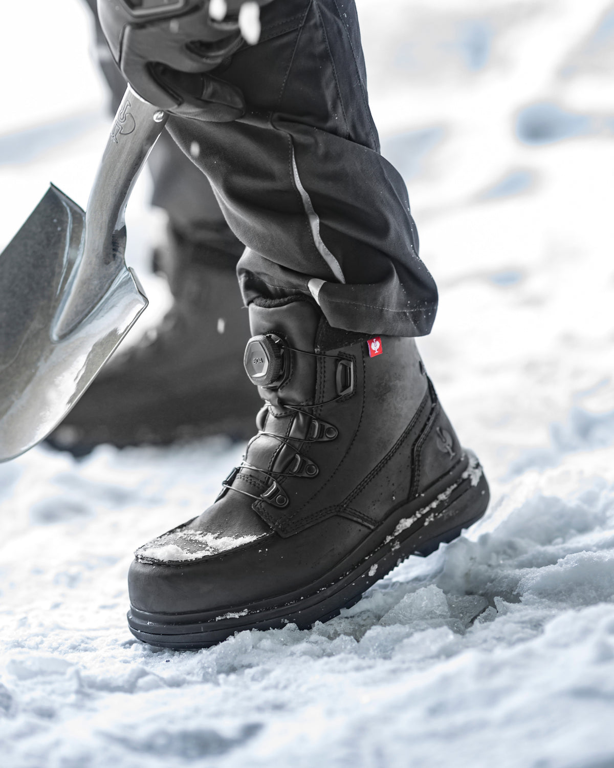 STRAUSS Woodside 6-inch Steel Toe Work Boot in Black shown on rough jobsite ground