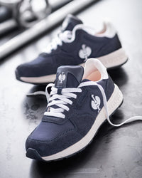 STRAUSS Canberra Steel Toe Work Shoe in Nero blue with workwear in a jobsite scene
