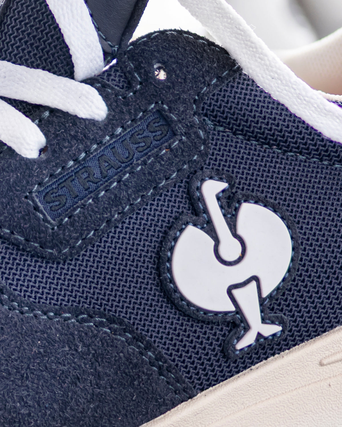 Close-up of the Canberra Steel Toe Work Shoe STRAUSS logo