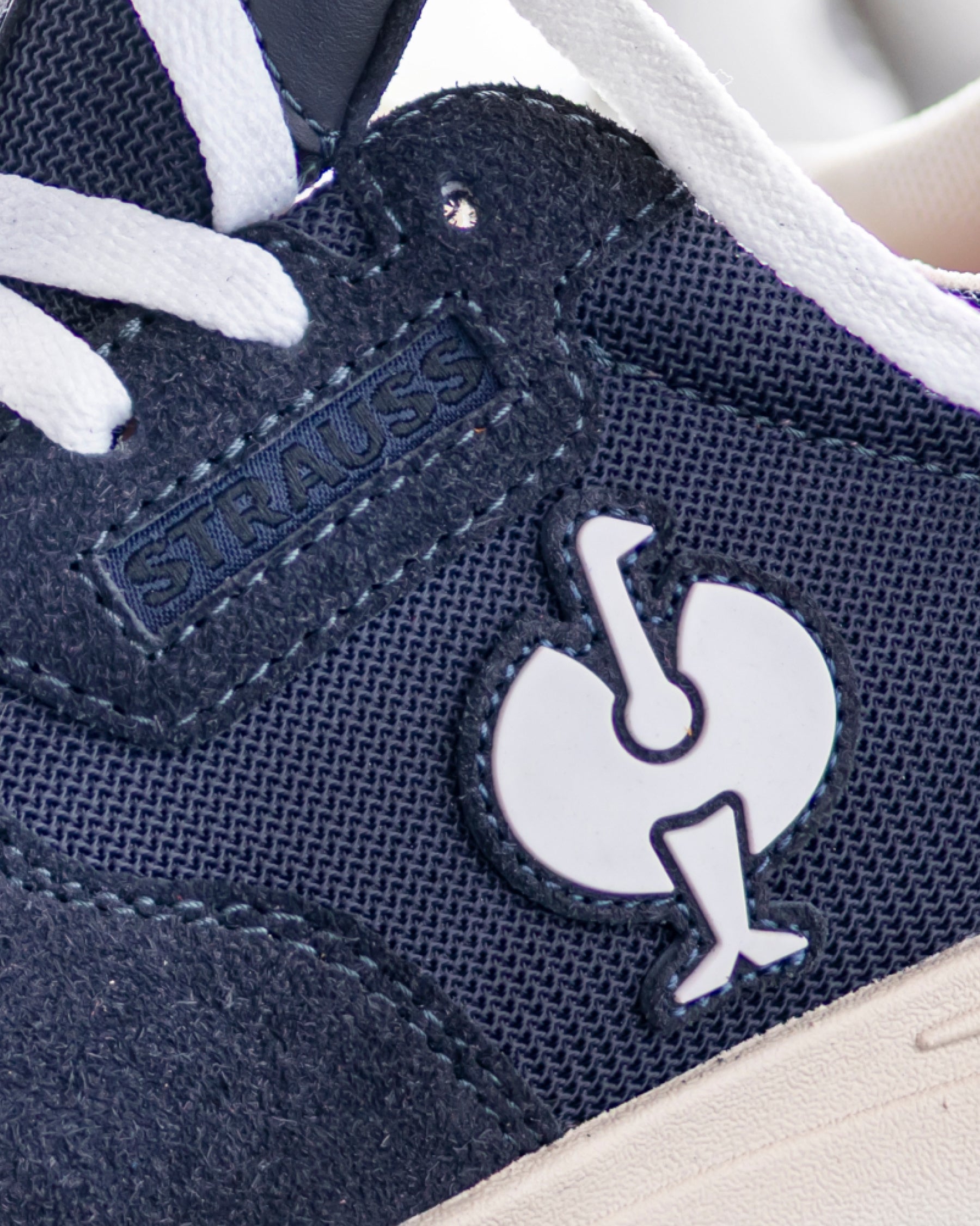 Close-up of the Canberra Steel Toe Work Shoe STRAUSS logo