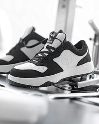 STRAUSS Eindhoven Steel Toe Work Shoe in Black and White worn in an outdoor work setting