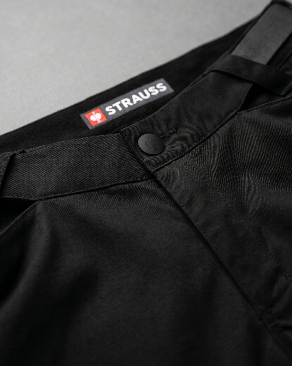 Additional close-up detail of Engelbert Strauss women's e.s. trail pure cargo work shorts in black and carbon gray, showing fabric texture, stitching, and functional finishing details.