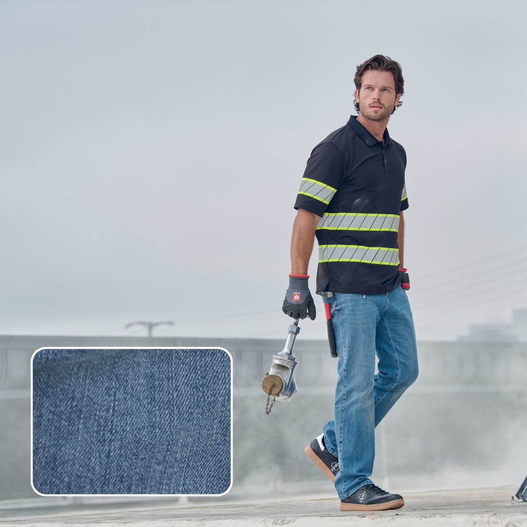 A man wearing denim jeans and a high-vis top, with the Dyneema fabric highlighted