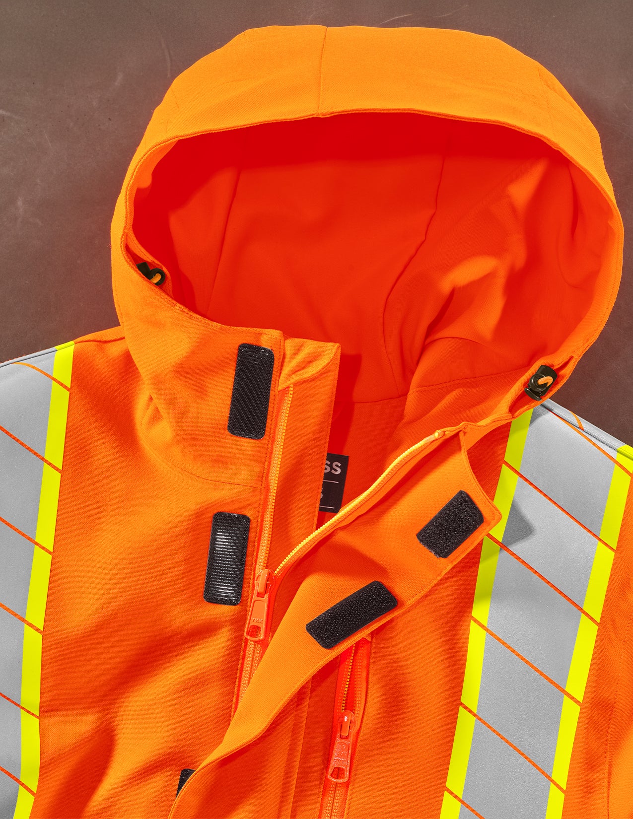 Orange safety jacket with reflective stripes on a grid background