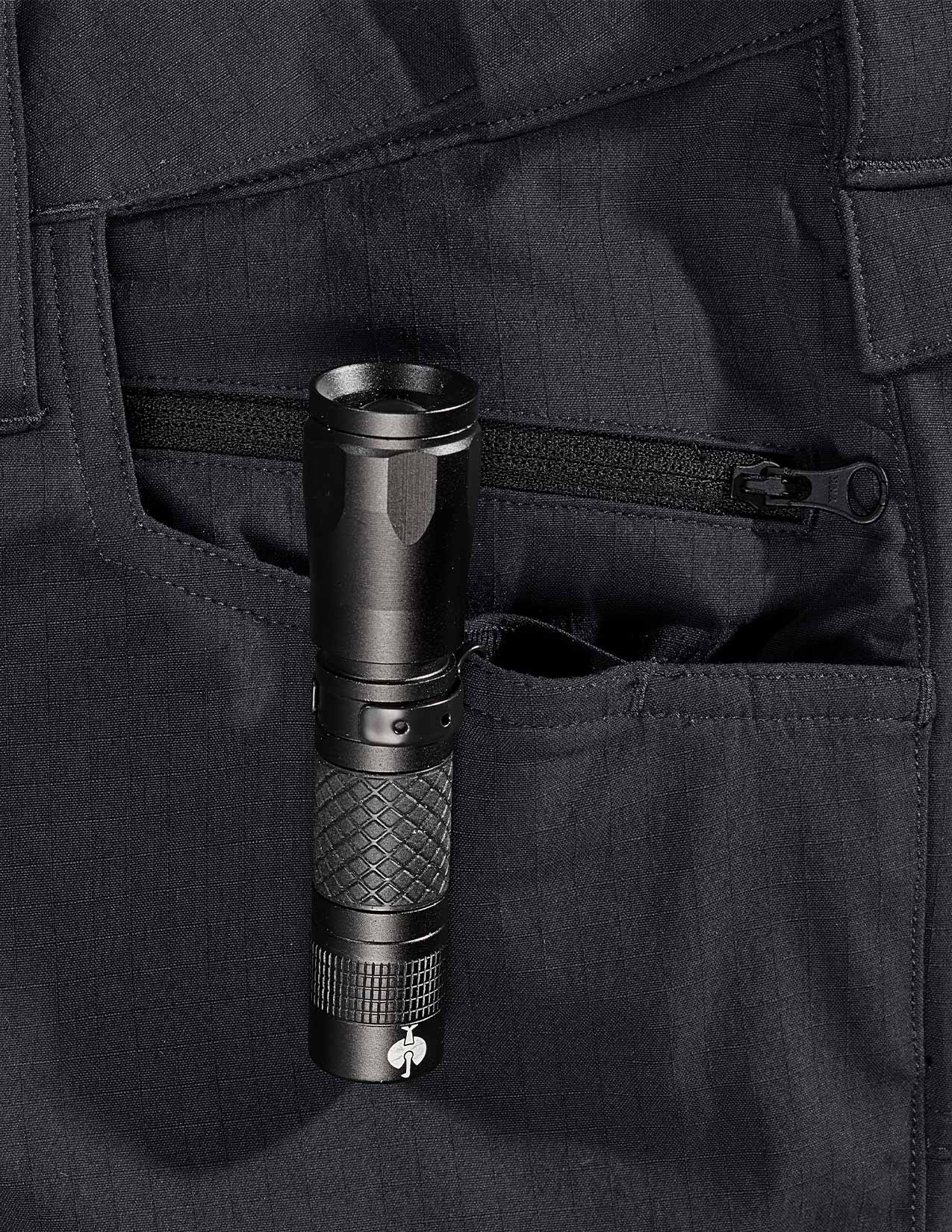 Black flashlight in a pocket of dark clothing