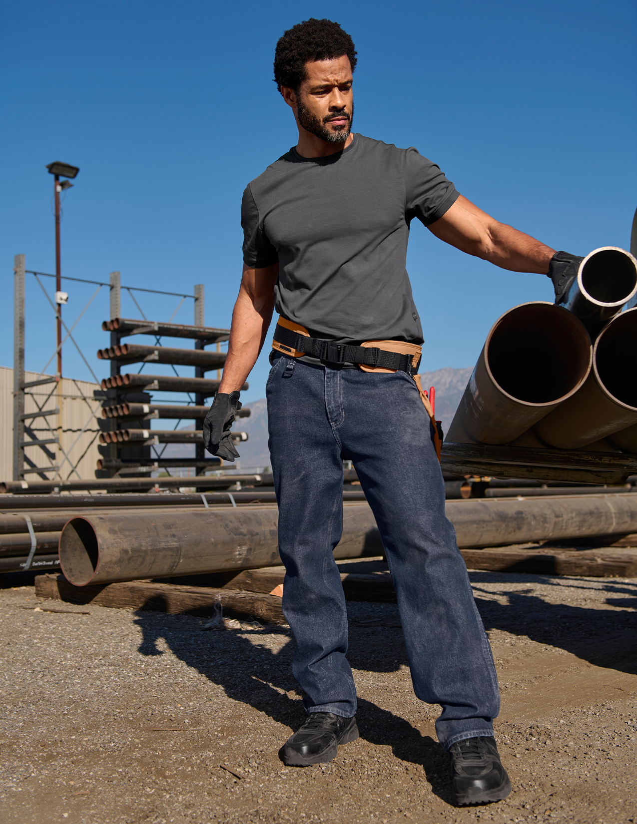 Man in tool belt and jeans.