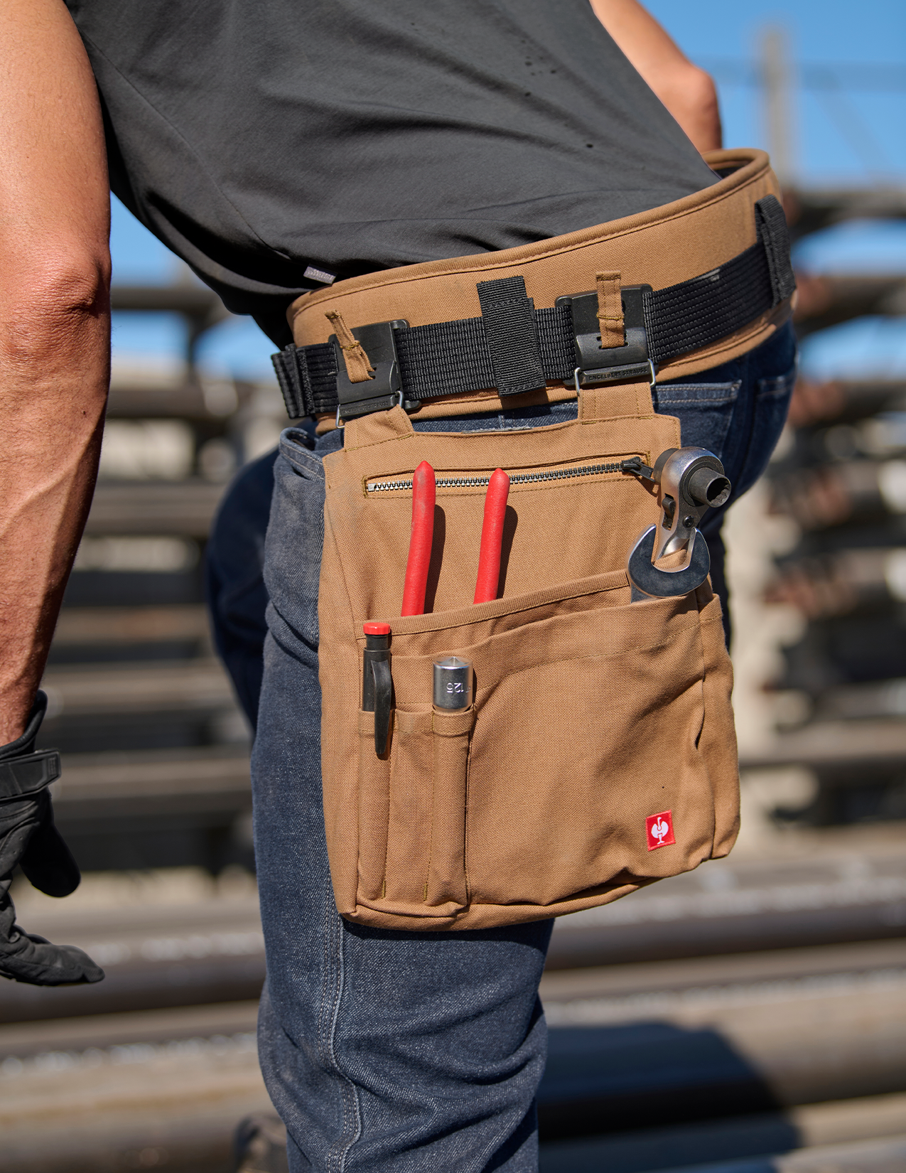 Close up of tool belt with bag attached holding tools