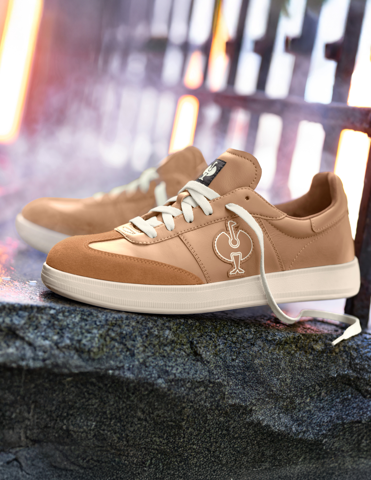 beige sneakers with a logo on a textured surface