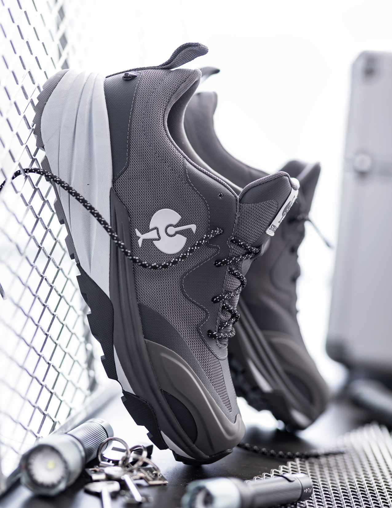 Gray sneakers with the brand logo on a metallic surface