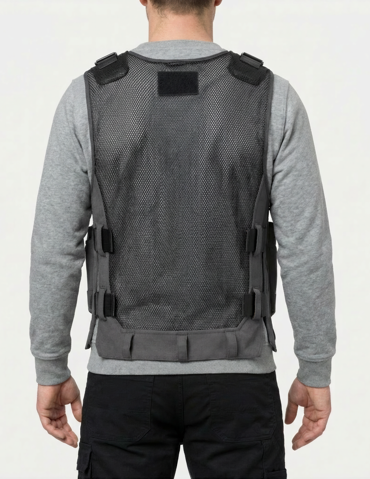 Person wearing a tool vest with a plain background